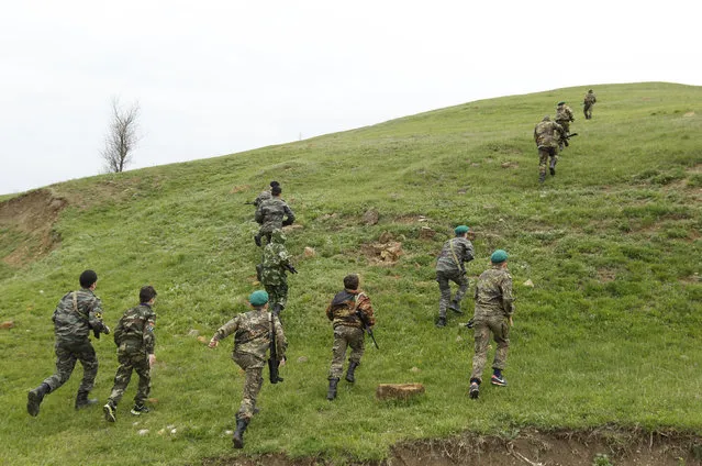 Students from the General Yermolov Cadet School run during a two-day field exercise near the village of Sengileyevskoye, just outside the south Russian city of Stavropol, April 13, 2014. (Photo by Eduard Korniyenko/Reuters)
