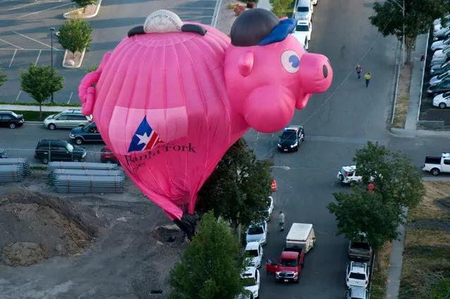 The Bank of American Fork piggy bank balloon crash lands near Utah Valley Regional Medical Center during America's Freedom Festival Balloon Fest on Thursday, July 2, 2015, in Provo, Utah. (Photo by Grant Hindsley/The Daily Herald via AP Photo)