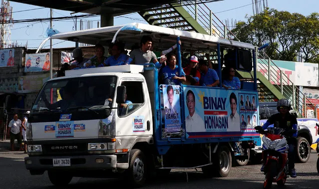 A motorcade of Presidential candidate Jejomar Binay and Filipino boxer and Senatorial candidate Manny Pacquiao passes by during election campaigning in Malabon Metro Manila in the Philippines May 6, 2016. (Photo by Erik De Castro/Reuters)