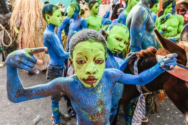 Children with painted faces participate in the Jacmel Carnival parade, in Jacmel, Haiti, 20 February 2022. In the midst of the social, political, and economic crisis that Haiti is going through, the festive atmosphere took over the streets of Jacmel, in the southeast of the country, with its traditional carnival parade, an annual celebration in which traditional dances and native masks stand out. (Photo by Johnson Sabin/EPA/EFE)