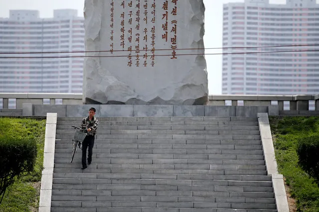 A man carries a bicycle down the stairs in central Pyongyang, North Korea May 9, 2016. (Photo by Damir Sagolj/Reuters)