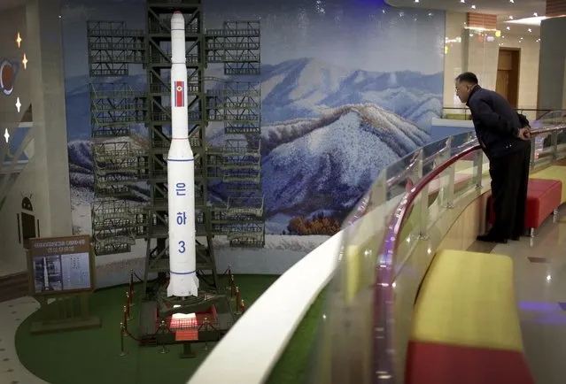 A North Korean man looks at a model of the Unha 3 space launch vehicle displayed at the Mangyongdae Children's Palace on Friday, April 14, 2017, in Pyongyang, North Korea. Amid rising regional tensions, Pyongyang residents have been preparing for North Korea's most important holiday: the 105th birth anniversary of Kim Il Sung, the country’s late founder and grandfather of current ruler Kim Jong Un. (Photo by Wong Maye-E/AP Photo)
