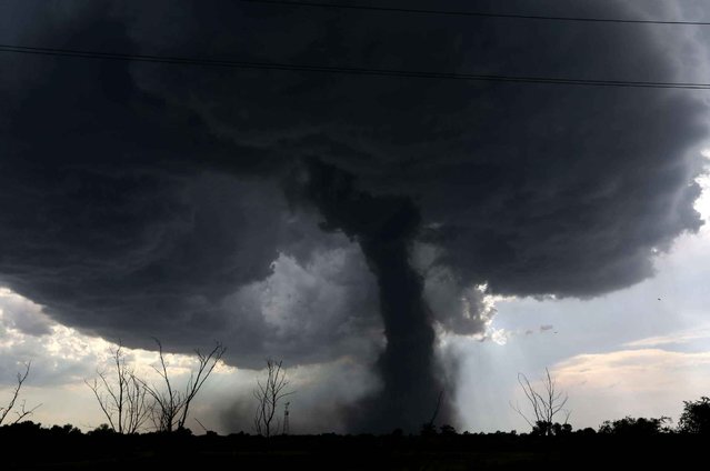 A tornado builds and travels southwest causing damage near Dean Rd. and 82nd Avenue in Hutchinson, Kan. on Monday, July 13, 2015. (Photo by Sandra J. Milburn/The Hutchinson News via AP Photo)