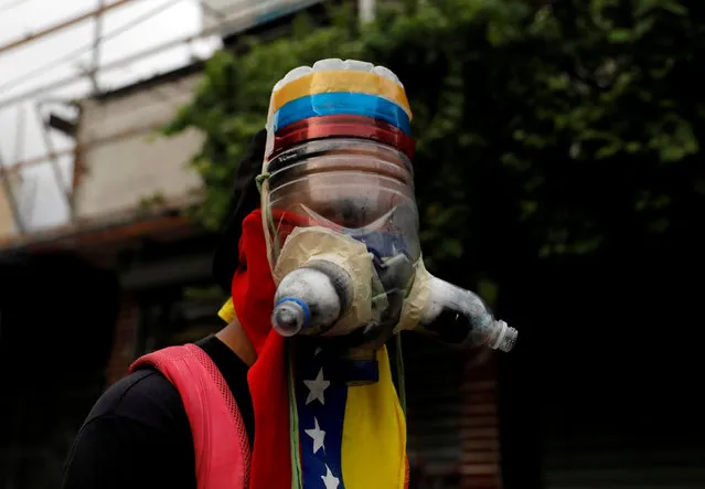 A demonstrator wears a homemade gas mask during rally against Venezuela's President Nicolas Maduro in Caracas, Venezuela May 1, 2017. (Photo by Carlos Garcia Rawlins/Reuters)