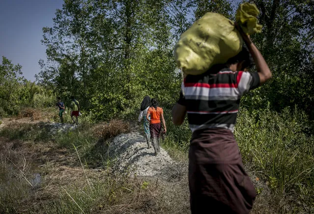 A Rohingya family fleeing from Dekibonia village in Myanmar crosses into Bangladesh on February 6, 2017 in Cox's Bazar, Bangladesh. The United Nations estimates about 69,000 Rohingya Muslims have fled to Bangladesh from Myanmar since October last year, after the Burmese army launched a campaign it calls 'clearance operations' in response to an attack on border police on October 9, believed to have been carried out by Rohingya militants. Waves of Rohingya civilians have since fled across the border, most living in makeshift camps and refugee centers with harrowing stories on the Burmese army committing human-rights abuses, such as gang rape, arson and extrajudicial killing. The Rohingya, a mostly stateless Muslim group numbering about 1.1 million, are the majority in Rakhine state and smaller communities in Bangladesh, Thailand and Malaysia. The stateless Muslim group are routinely described by human rights organizations as the “most oppressed people in the world” and a “minority that continues to face statelessness and persecution”.  (Photo by Allison Joyce/Getty Images)