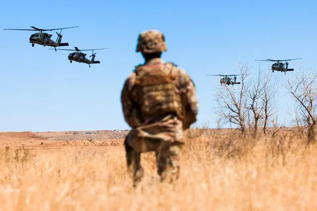 A soldier watches as cavalry scouts with the 2nd Stryker Brigade Combat Team prepare to land during Operation Steel Eagle on March 31, 2022 in Fort Carson, Colorado. The operation is a four-day exercise designed to synchronize air assault insertions with ground maneuvers and artillery fire. (Photo by Michael Ciaglo/Getty Images)