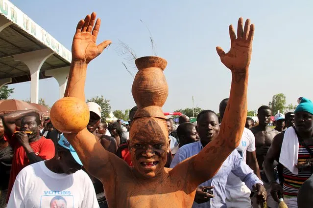 An entertainer performs during an annual traditional wrestling ceremony organized by the Kabye people in Pya, northern Togo, July 23, 2015. (Photo by Noel Kokou Tadegnon/Reuters)