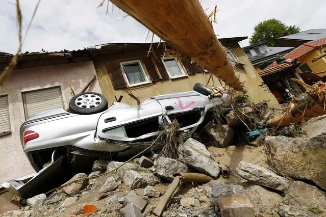 A damaged car is pictured after floods in the town of Braunsbach, Germany, May 30, 2016. (Photo by Kai Pfaffenbach/Reuters)