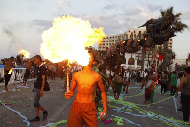 A fire breather performs during the Aoussou Carnival in Sousse, Tunisia July 26, 2015. (Photo by Anis Mili/Reuters)