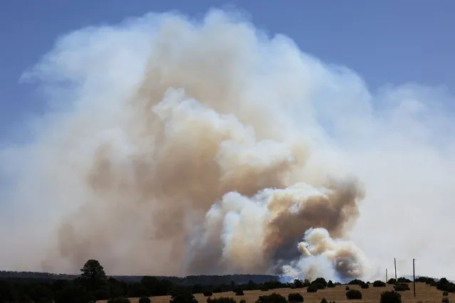 Large plumes of smoke rise from the Hermits Peak and Calf Canyon wildfires, near Las Vegas, New Mexico, U.S. May 4, 2022. (Photo by Kevin Mohatt/Reuters)