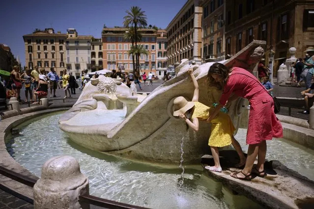People drink from Italian 17th Century sculptor Bernini's Barcaccia fountain, just next to the Spanish steps, in Rome, Monday, June 12, 2017. City hall on Monday announced that Mayor Virginia Raggi had signed an ordinance aimed at protecting some 40 fountains of historic or artistic interest to try to protect the monumental works, not infrequently trashed by tourists, sports fans and Romans. (Photo by Andrew Medichini/AP Photo)