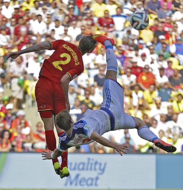 Russia's Alexander Kokorin performs a bicycle kick to clear the ball ahead of Belgium's Toby Alderweireld (2) during the group H World Cup soccer match between Belgium and Russia at the Maracana Stadium in Rio de Janeiro, Brazil, Sunday, June 22, 2014. (Photo by Natacha Pisarenko/AP Photo)