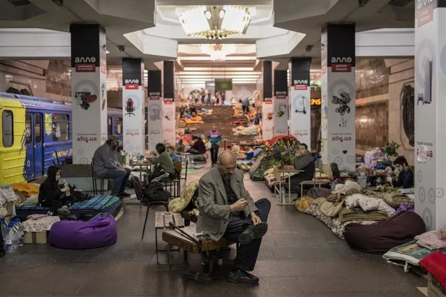 Residents stay in the city subway of Kharkiv, in eastern Ukraine, on Thursday, May 19, 2022. Although the bombings in Kharkiv have decreased and the subway is expected to run beginning of next week, still some residents use it as a temporary bomb shelter. (Photo by Bernat Armangue/AP Photo)