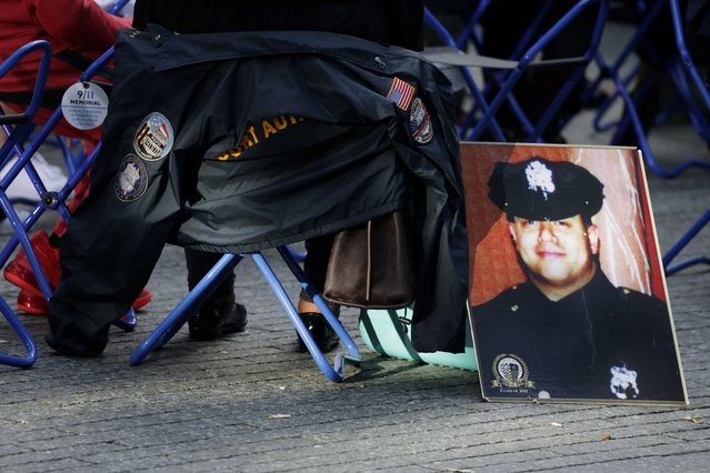 People sit during a ceremony marking the 23rd anniversary of the September 11, 2001 attacks on the World Trade Center at the 9/11 Memorial and Museum in Manhattan, New York City on September 11, 2024. (Photo by Kent J.Edwards/Reuters)