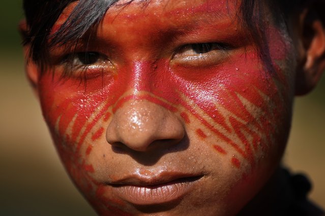 Indigenous youth Yawari Asheninka poses for a picture next to the Amonia River during the annual celebration recognizing the Ashaninka territory in the Apiwtxa village, Acre state, Brazil, Monday, June 24, 2024. (Photo by Jorge Saenz/AP Photo)