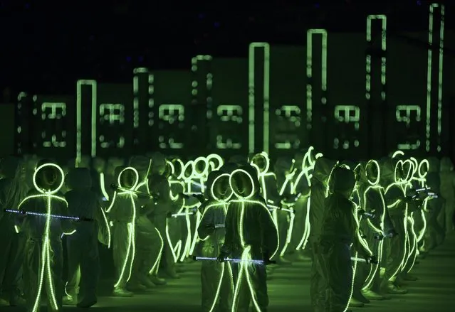 Children wearing LED-lit costumes perform during Singapore's Golden Jubilee celebration parade at Padang near the central business district August 9, 2015. (Photo by Kevin Lam/Reuters)