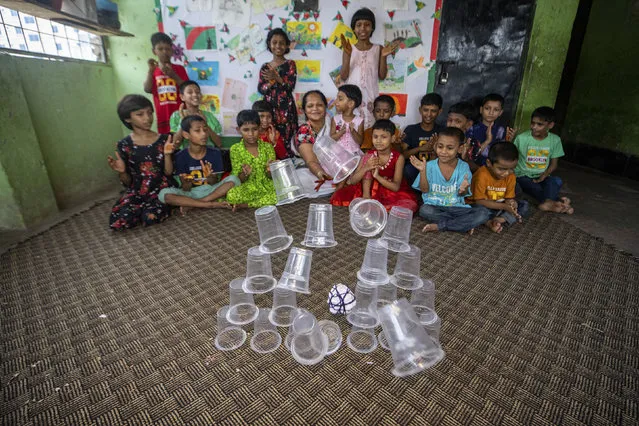 Hazera Begum taking care of children inside her shelter center in Dhaka Bangladesh on May 8, 2022. Hazera Begum, once a sеx worker, now has become a beacon of hope for the children of sеx workers, set up a shelter center named Shishuder Jonno Amra (We are for children) in Dhaka city where 46 children are residing. (Photo by Abdul Goni/Anadolu Agency via Getty Images)