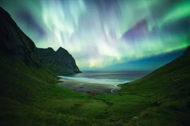 “Ignite the Lights”, Nicolas Alexander Otto (Germany). After a long hike from his small cabin to Kvalvika, Lofoten Islands in Norway, the photographer arrived at the slopes above the beach around midnight. During the hike the auroral display was relatively weak, but when he made it to the beach the sky ignited in a colourful spectacle of greens and purples framed by the mossy, green landscape. The image is stacked from six different exposures to combat high ISO and thermal noise in the foreground. The sky was added from one of these exposures. (Photo by Nicolas Alexander Otto/National Maritime Museum/The Guardian)