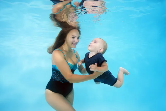 Mother and son seen posing under water in the pool on July 26, 2017 in Odessa, Ukraine. (Photo by Andrey Nekrasov/Barcroft Media)