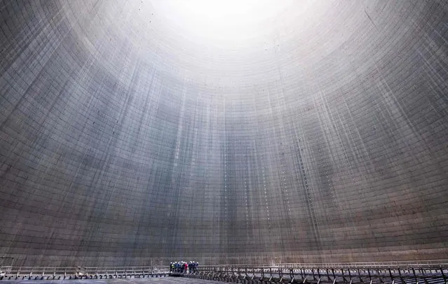 A picture taken on January 16, 2020 shows a group visiting the inside of a cooling tower at Mehrum coal-fired power plant in Hohenhameln, Germany. (Photo by Julian Stratenschulte/dpa/AFP Photo)