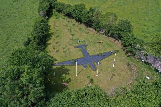 This aerial view taken on May 30, 2022 shows a US memorial garden shaped as a military transport aircraft Douglas C-47A with 20 trees in Picauville, close to Sainte-Mere-Eglise, north-western France. This garden honours the 20 American servicemen who died in this field on early June 6, 1944 during the D-Day allied invasion of Normandy that began the liberation of France during World War II. (Photo by Damien Meyer/AFP Photo)