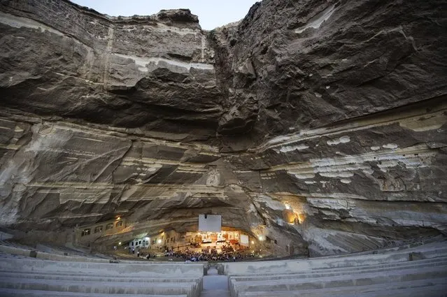 A general view of St Samaans (Simon) Church also known as the Cave Church in the Mokattam village, nicknamed as “Garbage City”, is seen on July 26, 2012 in Cairo. Once a week hundreds gather at the Cave Church in Moqattam, after the prayer, a coptic priest performs exorcism or healing blessing to some of the believers. With a cross and holy water he fights spiritual entities and demons. The Monastery of St. Simon the Tanner is the largest and it has an amphitheater with a seating capacity of 20,000 making it the largest church in the Middle East. It is named after the Coptic Saint, Simon the Tanner, who lived at the end of the 10th century, when Egypt was ruled by the Muslim Fatimid Caliph Al-Muizz Lideenillah. Simon the Tanner is the Coptic Saint who is associated with the legend of the moving of the Mokattam Mountain. (Photo by Gianluigi Guercia/AFP)