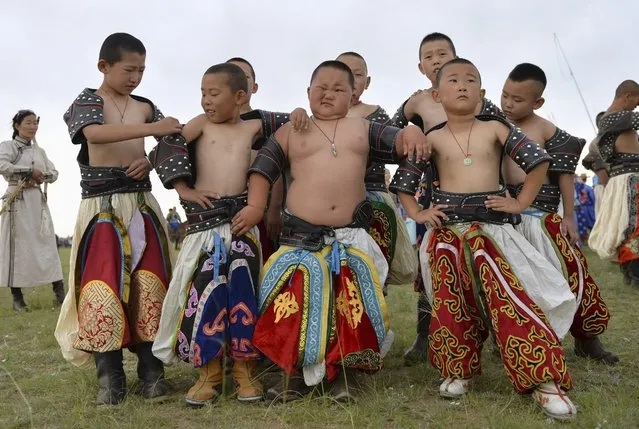 Young wrestlers gather during a traditional Nadam fair in Xilin Gol League, in China's Inner Mongolia Autonomous Region, July 28, 2014. (Photo by Jacky Chen/Reuters)