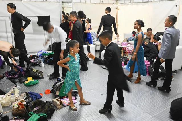 Tango dancers wait backstage for their turn, during the closing event of the Medellin Tango Festival in Medellin, on June 26, 2022. (Photo by Joaquín Sarmiento/AFP Photo)