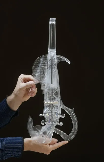 French engineer and professional violinist Laurent Bernadac poses with the “3Dvarius”, a 3D printed violin made of transparent resin, during an interview with Reuters in Paris, France, September 11, 2015. (Photo by Christian Hartmann/Reuters)