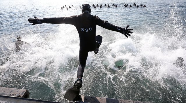 Members of South Korean Navy's elite Sea Salvage and Rescue Unit jump into the sea at a naval port in Changwon, South Korea, 17 January 2025, as part of their cold weather exercise. (Photo by Yonhap/EPA/EFE)
