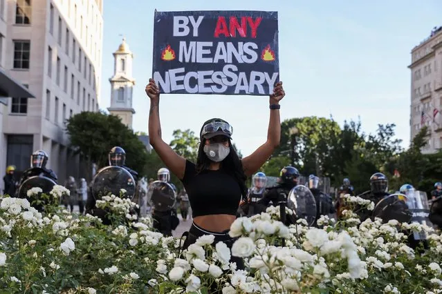 A demonstrator holds a placard during a protests against the death in Minneapolis custody of George Floyd, near the White House in Washington, D.C., U.S., June 1, 2020. (Photo by Jonathan Ernst/Reuters)