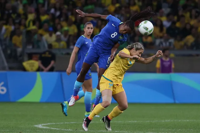 Brazil's Formiga, left, jumps for a header over Australia's Katrina Gorry during a quarter-final match of the women's Olympic football tournament between Brazil and Australia at the Mineirao Stadium in Belo Horizonte, Brazil, Friday August 12, 2016. (Photo by Eugenio Savio/AP Photo)