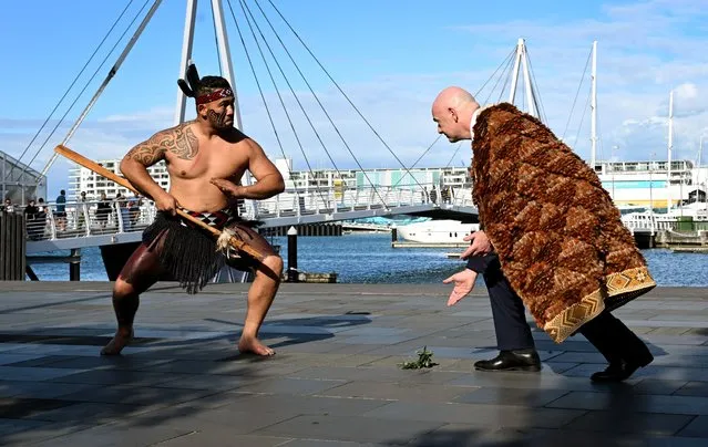 FIFA president Gianni Infantino (R) accepts a Warrior Challenge at an official Maori welcome a day before the football draw ceremony for the Australia and New Zealand 2023 FIFA Women's World Cup, in Auckland on October 21, 2022. (Photo by William West/AFP Photo)