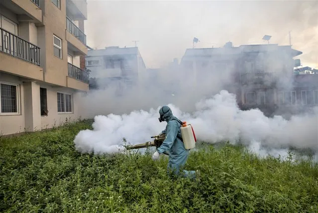 An All Nepal Pest Control worker sprays insecticide to kill mosquitoes and prevent an outbreak of dengue fever in Kathmandu, Nepal, 16 September 2022. According to the Ministry of Health and Population, the disease has spread in 75 out of 77 districts of Nepal. A dozen people have died from dengue so far, while over 10,000 infections have been reported across the country. (Photo by Narendra Shrestha/EPA/EFE/Rex Features/Shutterstock)