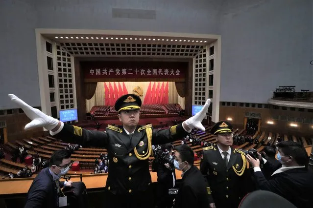A director conducts band members as they perform during the closing ceremony of the 20th National Congress of China's ruling Communist Party at the Great Hall of the People in Beijing, Saturday, Ocober. 22, 2022. (Photo by Ng Han Guan/AP Photo)