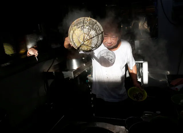 Hawker Wee Phong Sai, 66, cooks fishball noodles at his Thye Hong Handmade Fishball Noodle stall at Ghim Moh food center in Singapore May 21, 2016. “I have been here, at this stall, since 1977; all of my five brothers sell fishball noodles, although two of them have retired. I continue to make fishballs by hand because it gives them a softer texture”, he said. “To retire? These are two words that I will not utter”. (Photo by Edgar Su/Reuters)
