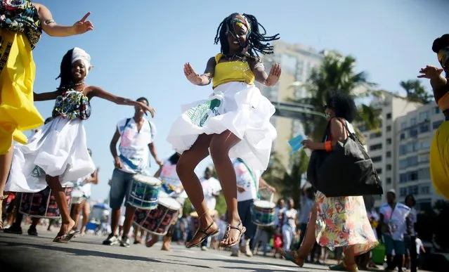 Afro-Brazilian worshippers dance at a march for religious freedom on September 20, 2015 in Rio de Janeiro, Brazil. The march included practitioners of Candomble, Umbanda, Buddhism and Christianity. Practiioners of Afro-Brazilian religions remain persecuted to this day in spite of attempts at post-slavery reforms to integrate Africa-based religions. (Photo by Mario Tama/Getty Images)