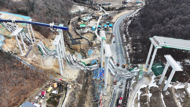 Rescuers work at the construction site of a bridge on the Seoul-Sejong expressway, after it collapsed earlier in the day, leaving three workers dead and five others injured in Anseong, South Korea, 25 February 2025. (Photo by Yonhap/EPA)