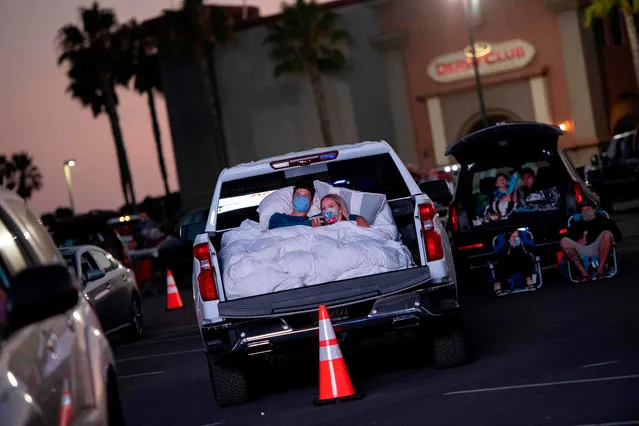 People listen to US country singer Randy Houser perform during the drive-in live music event “Concerts in your Car” at the Ventura County Fairgrounds and Event Center, in Ventura, California, on July 11 2020, amid the coronavirus pandemic. (Photo by Valerie Macon/AFP Photo)