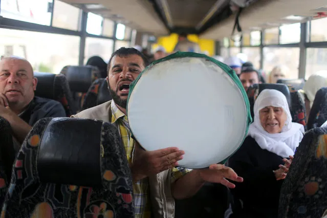 Palestinians chant religious slogans as they sit in a bus before leaving for the annual Haj pilgrimage in Mecca, at the Rafah crossing between Egypt and southern Gaza Strip August 30, 2016. (Photo by Ibraheem Abu Mustafa/Reuters)