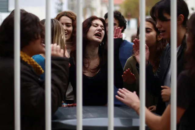 Students of Camoes school shout slogans from inside the school after blocking the entrance as a protest for climate change and against the use of fossil fuels in Lisbon, Portugal on November 14, 2022. (Photo by Pedro Nunes/Reuters)