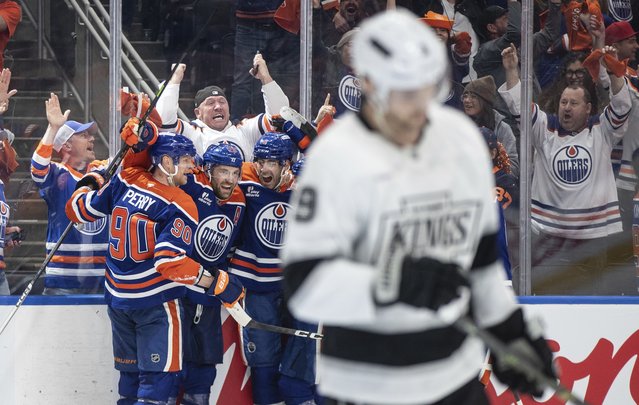 Edmonton Oilers' Corey Perry Photo: 90), Leon Draisaitl Photo: 29) and Evan Bouchard Photo: 2) celebrate the game-winning goal against the Los Angeles Kings in an overtime of an NHL playoff gamen in Edmonton on Sunday, April 27, 2025. (Photo by Jason Franson/The Canadian Press via AP Photo)