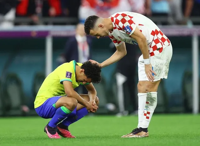 Marquinhos of Brazil reacts with Ivan Perisic of Croatia after missing the deciding penalty in the penalty shoot out during the FIFA World Cup Qatar 2022 quarter final match between Croatia and Brazil at Education City Stadium on December 09, 2022 in Al Rayyan, Qatar. (Photo by Hannah Mckay/Reuters)