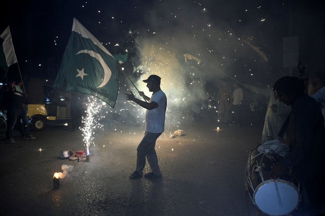 People celebrate after the ceasefire announcement between India and Pakistan, in Hyderabad, Pakistan, on May 10, 2025. (Photo by Yasir Rajput/Reuters)