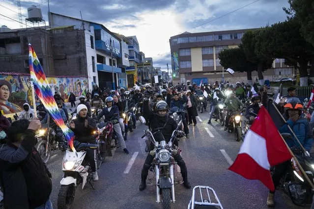 Anti-government protesters participate in a motorcycle caravan in Juliaca, Peru, Monday, January 30, 2023. Protesters are seeking immediate elections, President Dina Boluarte's resignation, closure of the Congress and the release of President Pedro Castillo, who was ousted and arrested for trying to dissolve Congress in December. (Photo by Rodrigo Abd/AP Photo)