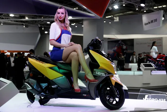 A model poses with TVS NTorq 125 scooter at the India Auto Show 2018 in Greater Noida, India February 8, 2018. (Photo by Saumya Khandelwal/Reuters)