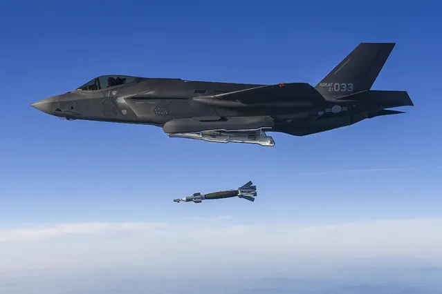 In this photo provided by South Korean Defense Ministry, South Korean Air Force F-35 fighter jet fires a GBU-12 aerial laser-guided bomb at a firing range near its land border with North Korea, South Korea, Friday, November 18, 2022. South Korea's military said Friday its F-35 fighter jets conducted drills simulating aerial strikes on North Korean mobile missile launchers at a firing range near its land border with North Korea. It said a group of eight South Korean and U.S. fighter jets separately performed flight training off the Korean Peninsula's east coast. (Photo by South Korean Defense Ministry via AP Photo)