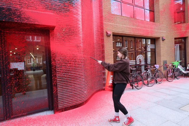 An activist from Youth Demand attacks the Labour party headquarters in London on April 7, 2024. The campaign group is calling for action to curb climate change and for the end of arms sales to Israel. (Photo by Tom Bowles/The Times)
