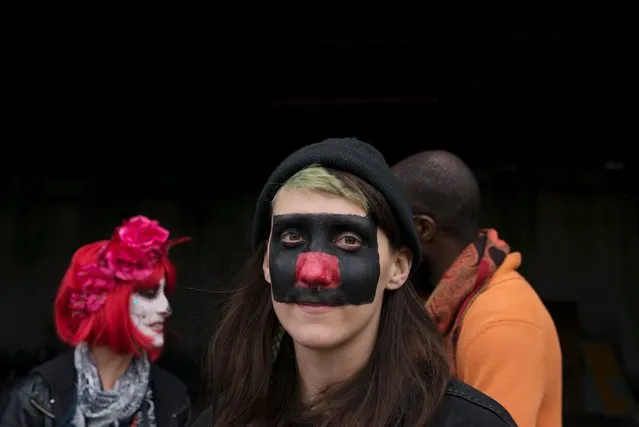 A woman with face paint poses for a photograph during "Bike Kill 12" in the Brooklyn borough of New York City, October 31, 2015. (Photo by Stephanie Keith/Reuters)