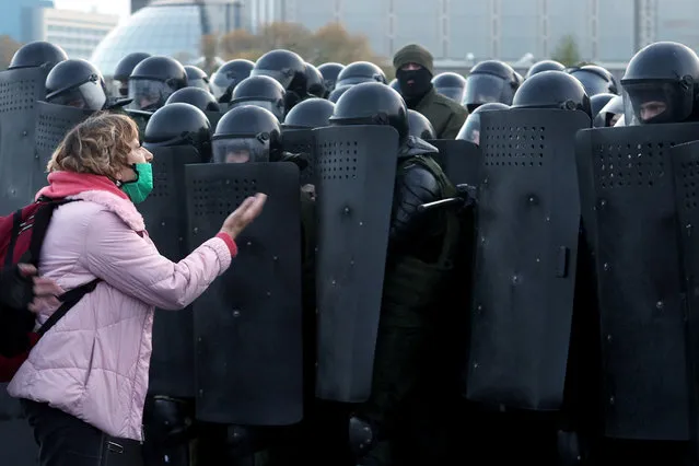 A woman argues with law enforcement officers during an opposition rally in Minsk, on October 25, 2020, on the final day of an ultimatum set by the opposition for their embattled strongman leader to resign after months of mass protests. (Photo by AFP Photo/Stringer)